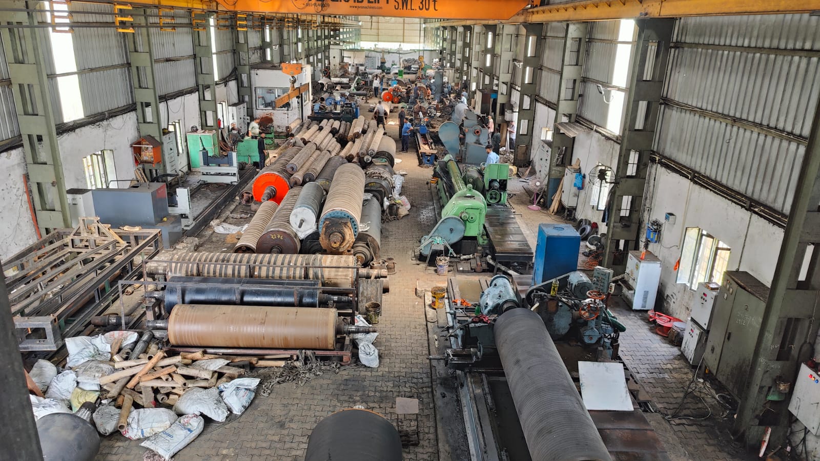 Industrial roll maintenance area with multiple rolls under service