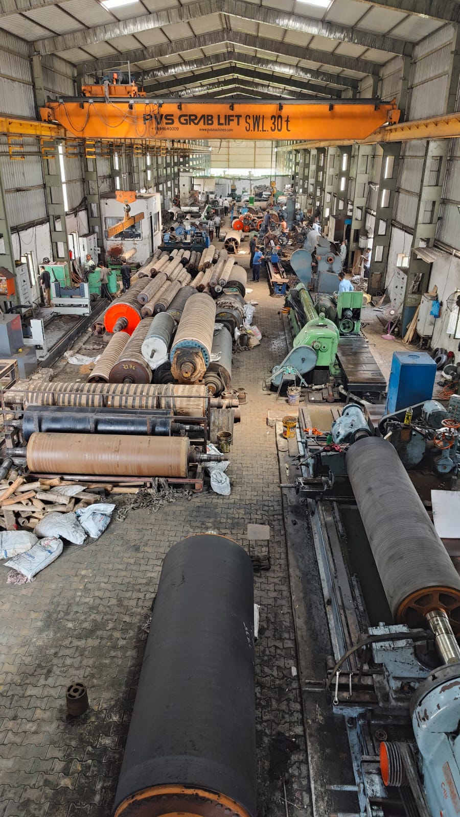 Large rubber rolls and paper mill rolls inside Doghat manufacturing facility
